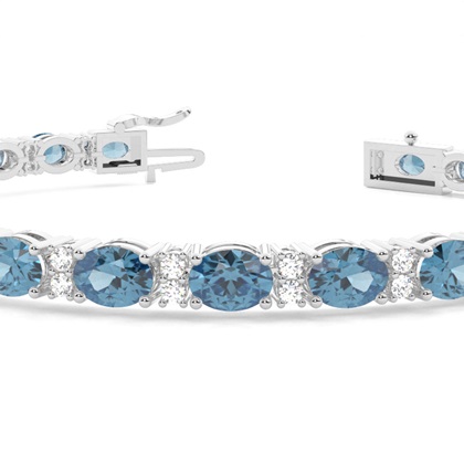 Ovales Tennisarmband mit blauem Topas in 4 Krappenfassungen