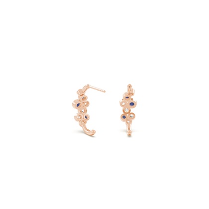 Blue sapphire and round diamond bezel set half hoop earring