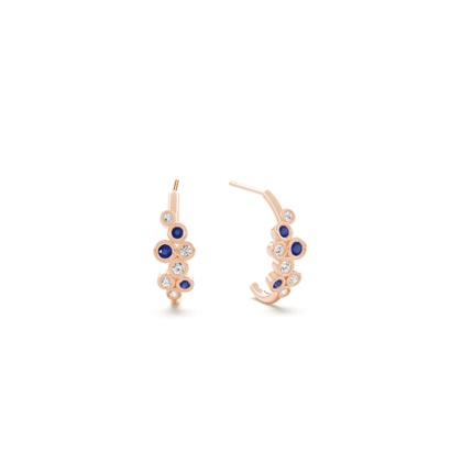 Blue sapphire and round diamond bezel set half hoop earring